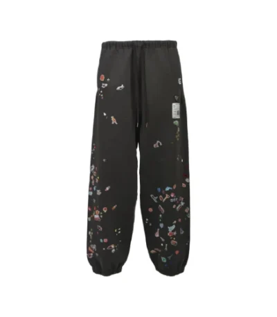 Front view of Maison Mihara Yasuhiro Black Stickers Track Pants with sticker graphic details