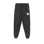 Front view of Maison Mihara Yasuhiro Patch-Detail Track Pants with designer patch accents