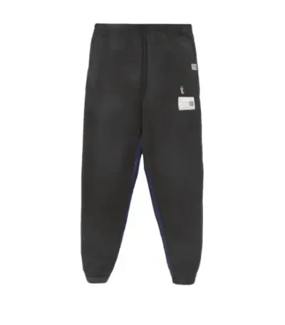 Front view of Maison Mihara Yasuhiro Patch-Detail Track Pants with designer patch accents