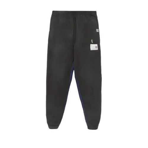 Front view of Maison Mihara Yasuhiro Patch-Detail Track Pants with designer patch accents