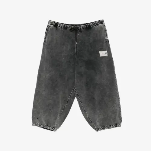 Front view of bleached wide-leg track pants with a relaxed streetwear silhouette