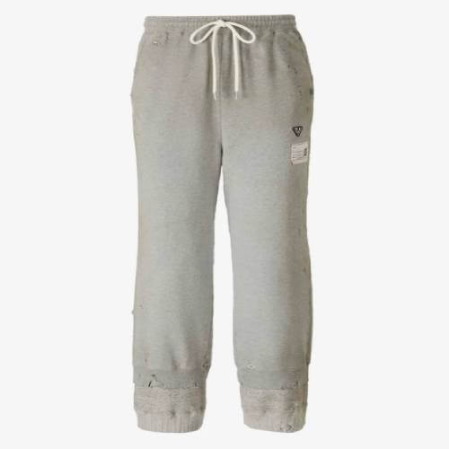 Front view of relaxed trousers featuring a distinctive distressed hem