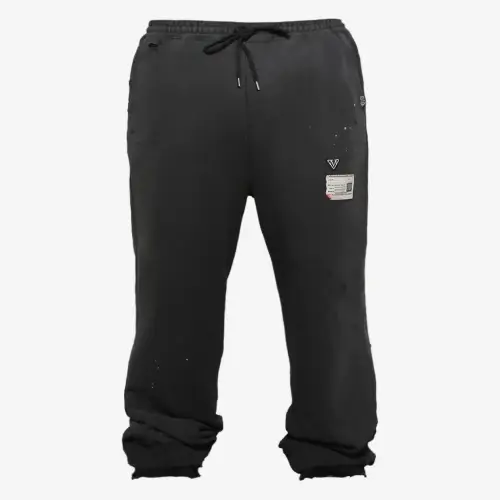Front view of Maison Mihara Yasuhiro Distressed Track Pants highlighting the distressed design.