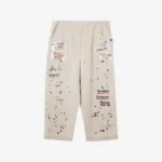 Front view of Maison Mihara Yasuhiro Embellished Sticker Sweat Trousers highlighting the decorative details.
