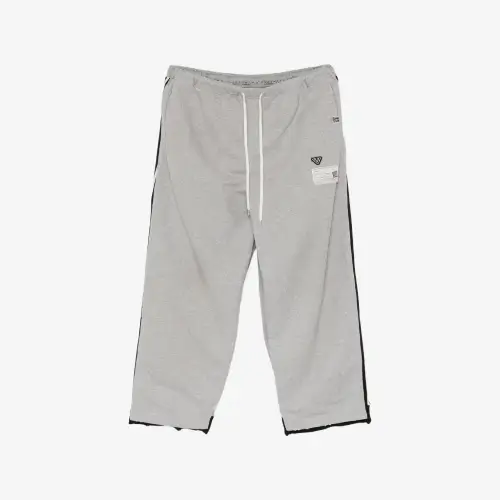 Front view of Maison Mihara Yasuhiro Track Pants Combined Sweat Pants showcasing the distinctive mixed-design construction.