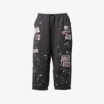 Maison Mihara Yasuhiro Embellished Sticker Sweat Pants front view with decorative sticker graphics