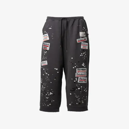 Maison Mihara Yasuhiro Embellished Sticker Sweat Pants front view with decorative sticker graphics